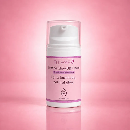 A bottle of FLORAFX Peptide Glow BB Cream with a white pump and clear cap, set against a soft pink gradient background with a subtle reflection.